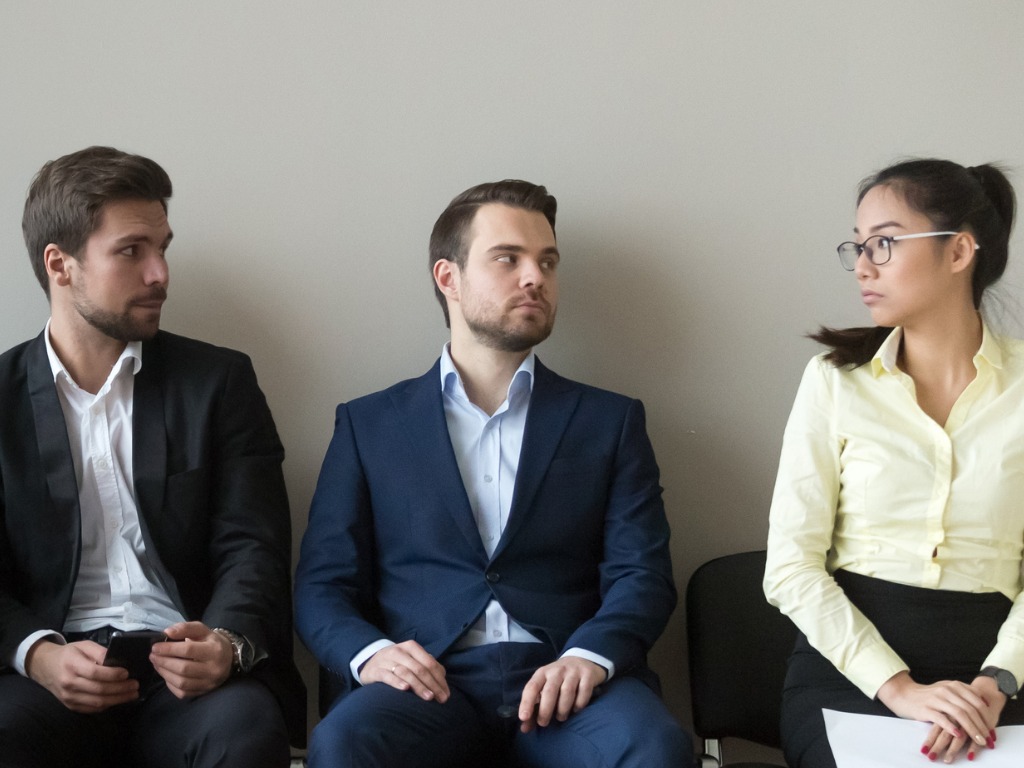 diverse-male-applicants-looking-at-female-rival-waiting-for-interview-picture-id1129629362 (1)