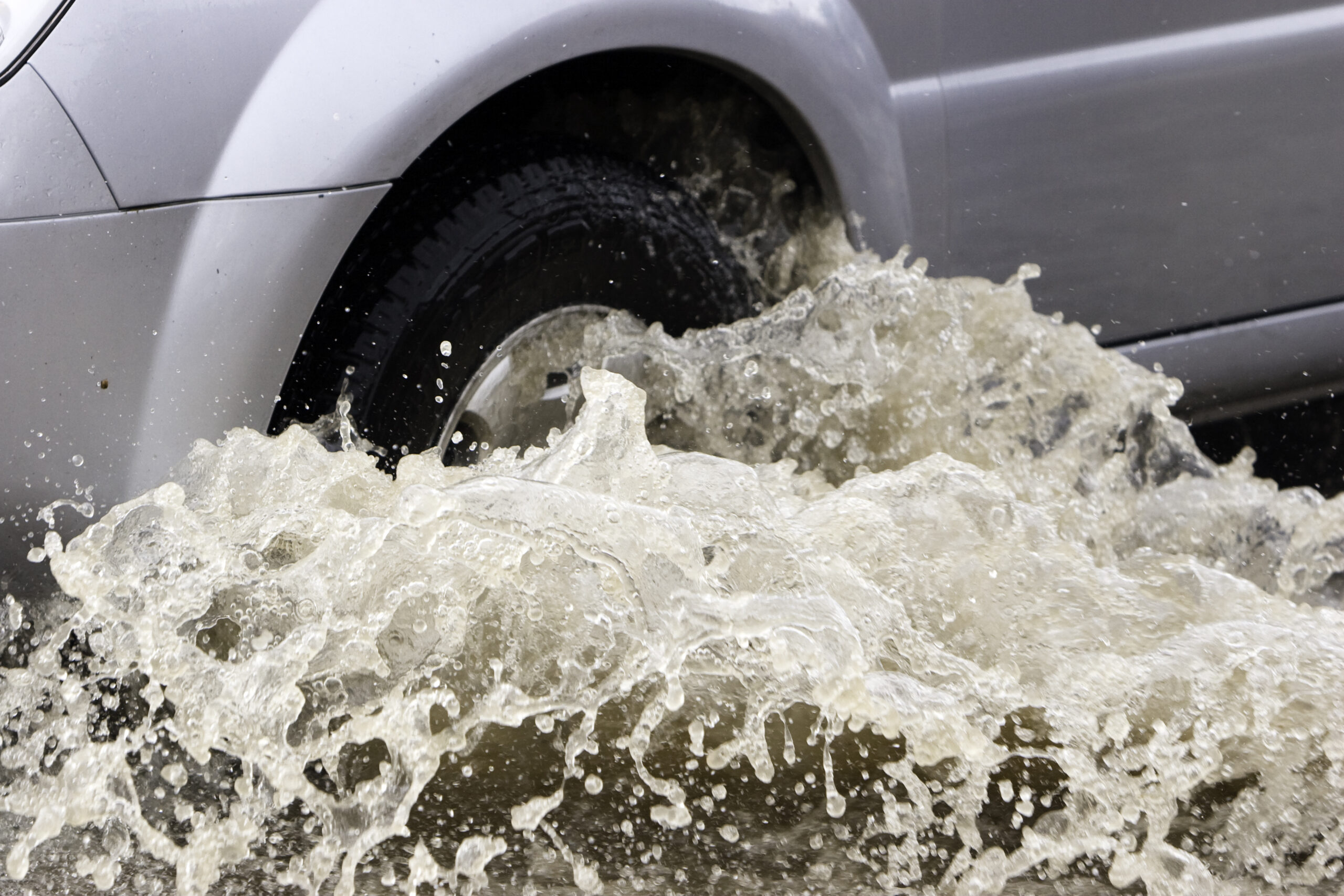 Splash by a car as it goes through flood water