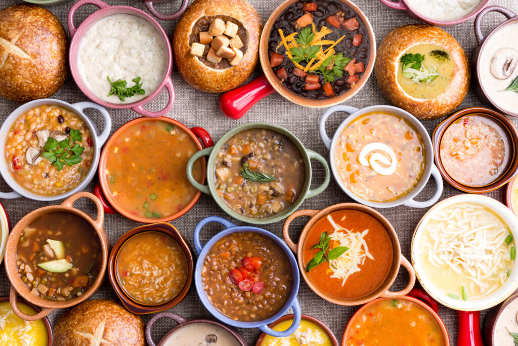 Variety of Garnished Soups in Colorful Bowls