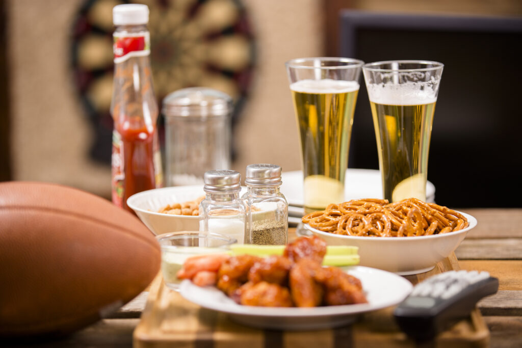 Watching football game on television at local pub. Food, beer.