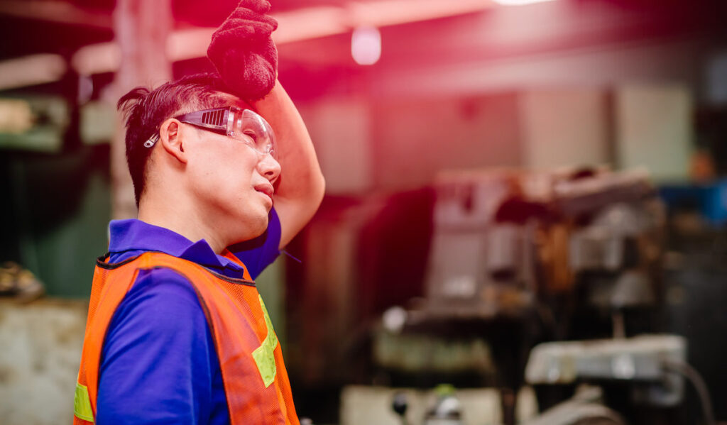 Tired worker, headache hot weather over heat unhealthy engineer working in heavy industry factory.