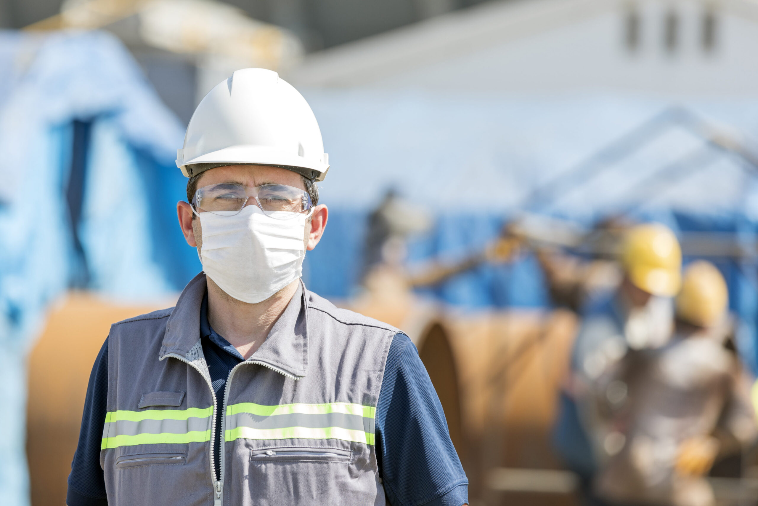 The worker is using personal protective equipments. For healthcare professionals caring for people with covid-19, the CDC recommends placing the person in an airborne infection isolation room.