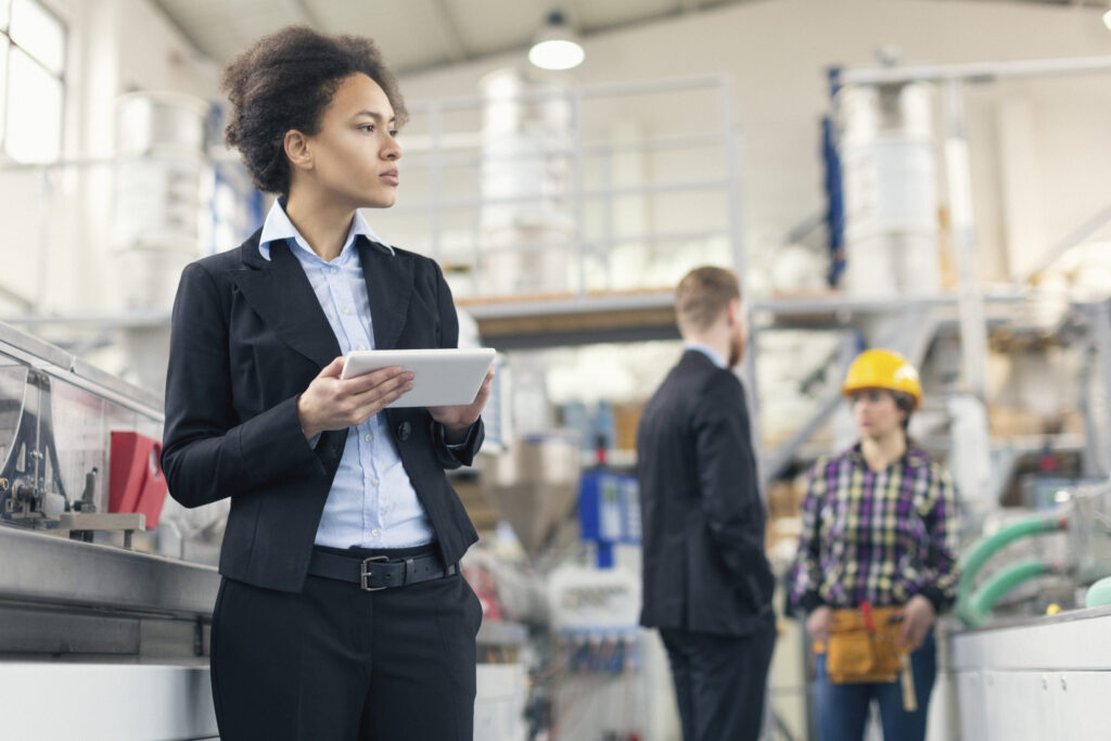 Female quality control inspector using tablet pc