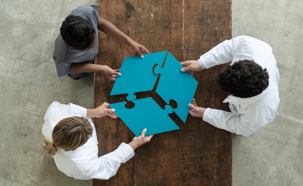 Medical professionals putting a 3 piece puzzle together