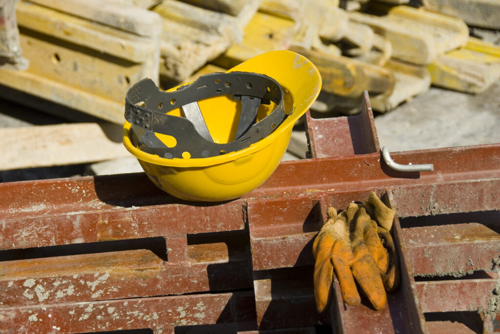 View of hard hat and gloves at construction site