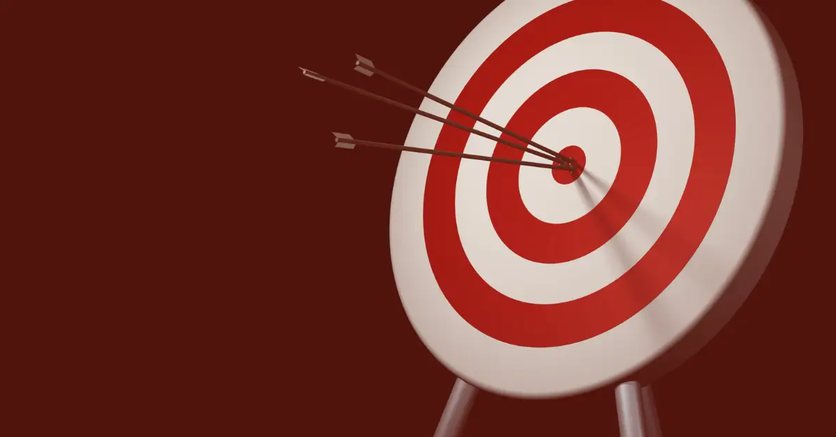 A target with red and white concentric circles has three arrows clustered in the bullseye, symbolizing data-driven safety, against a dark red background.