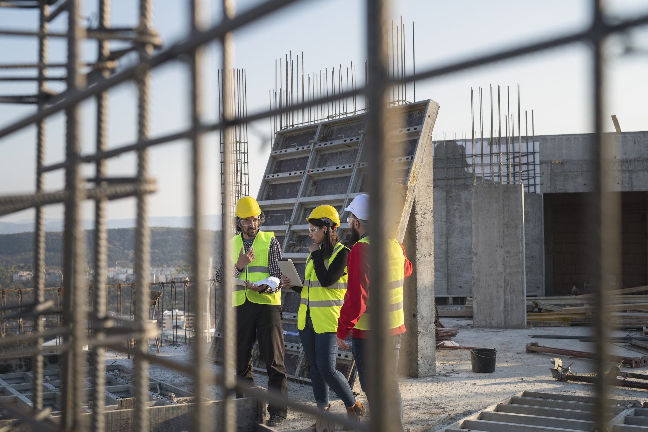 Construction workers discuss the building plans.