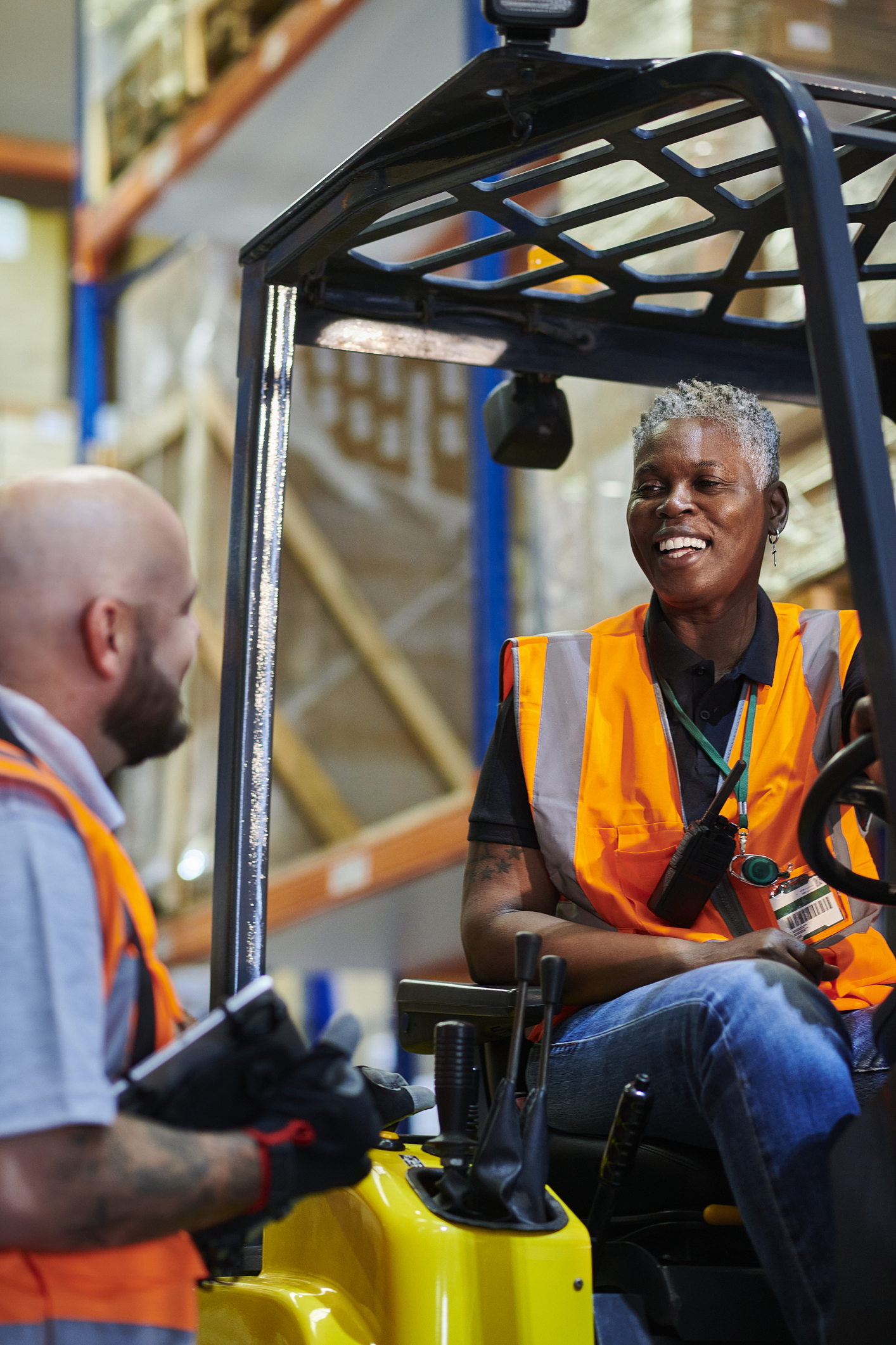 Two people talking one is in a forklift and the other is holding a clipboard - KPA EHS Safety Software Basic Forklift Training