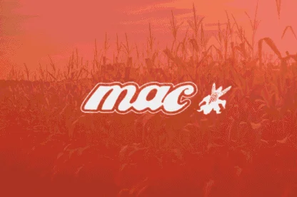 A cornfield under an orange filter with the word "mac" and a small winged horse logo in white overlaid at the center.