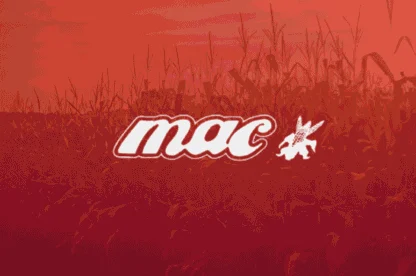 A stylized “mac” logo with a small winged animal appears centered over a field of corn under a reddish-orange sky.