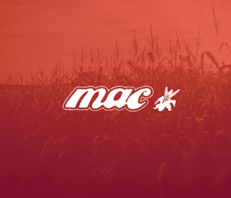 A stylized “mac” logo with a small winged animal appears centered over a field of corn under a reddish-orange sky.
