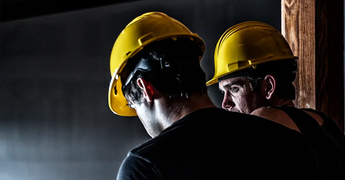 closeup of men wearing hard hats to stay safe