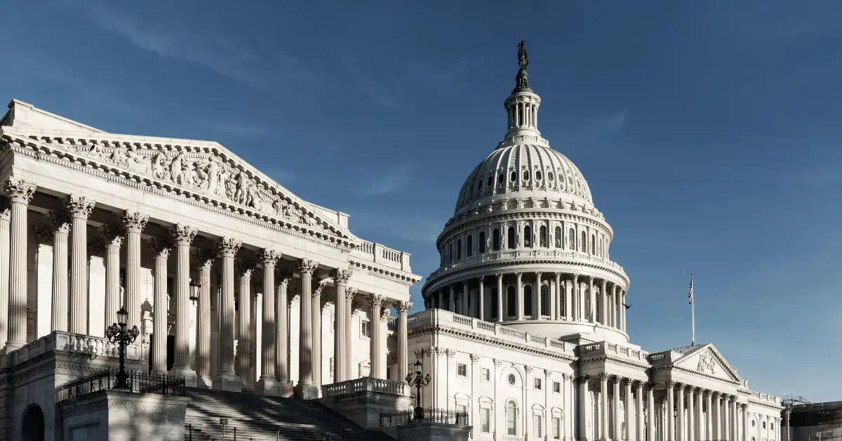 The United States Capitol building with its dome and columns under a clear blue sky, photographed during daytime, stands as a symbol of the nation’s commitment to regulatory compliance and effective governance.